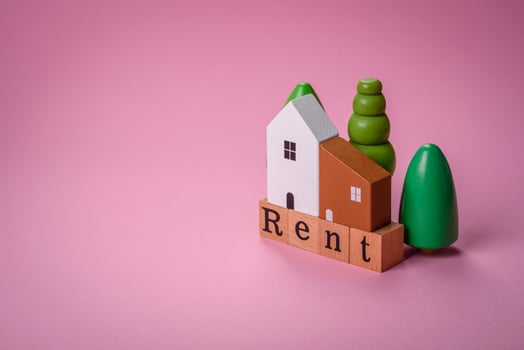 Small wooden house and the inscription for rent. Concept for sale, rental of real estate for a family photo