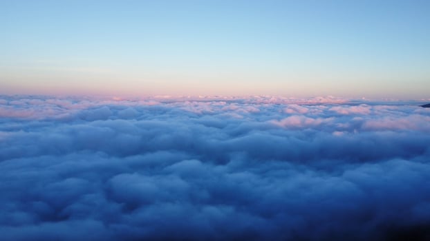 Aerial view over the mountains with sea of fog during morning sunrise in blue sky. Sea of clouds around mountain peaks at sunrise. Unseen travel in Northern Thailand photo