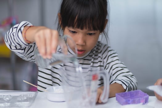 Cute little girl making DIY plaster and painting at home. Children paint on plaster sculptures with family on holiday. Imagination and creativity activities. photo