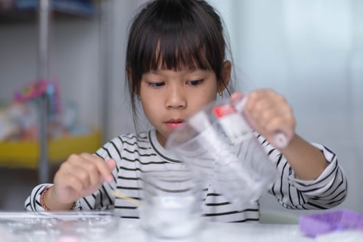 Cute little girl making DIY plaster and painting at home. Children paint on plaster sculptures with family on holiday. Imagination and creativity activities. photo