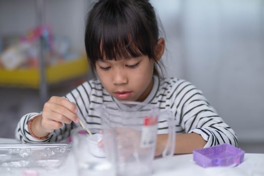 Cute little girl making DIY plaster and painting at home. Children paint on plaster sculptures with family on holiday. Imagination and creativity activities. photo