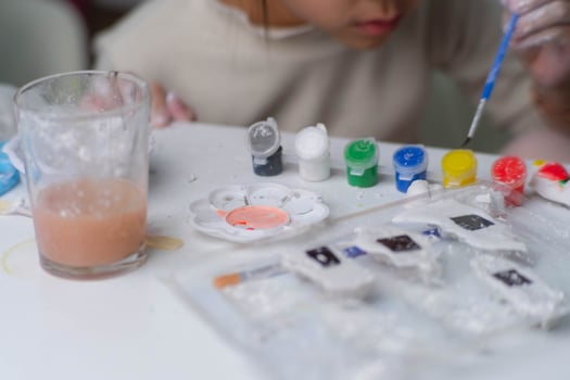 Cute little girl making DIY plaster and painting at home. Close-up of children painting on plaster sculpture with family on holiday. Imagination and creativity activities. photo