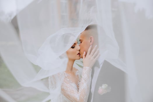 Wedding. Love and couple in garden for wedding. Celebration of ceremony and commitment. Save the date. Trust. The bride and groom embrace. The groom embraces the bride under the veil. photo