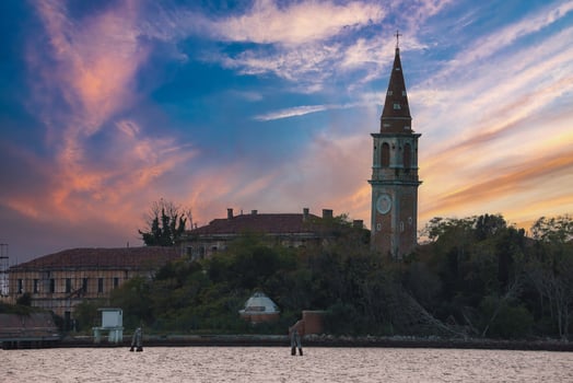 Poveglia Island with Traditional Church Surrounded by Serene Blue Water photo