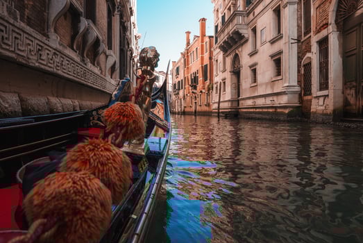 Iconic Gondola Navigating Through Venice Canal - Summer Collection photo