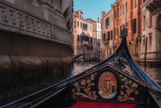 Iconic Gondola Gliding Along Peaceful Canal in Venice, Italy - Classic Venetian Architecture photo