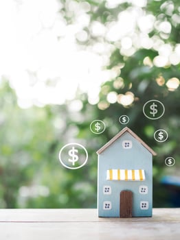 Miniature house and Dollar coin icons. The concept of price of house, Property investment, House mortgage, Real estate photo