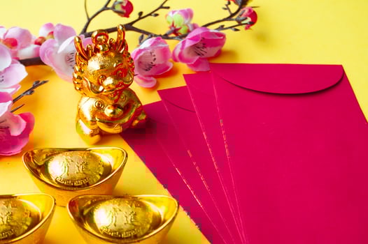 Top view of Chinese New Year red packet, cherry blossom and golden ingots decoration. Copy space. photo
