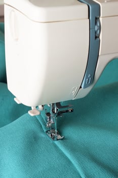 Modern sewing machine and turquoise fabric photo