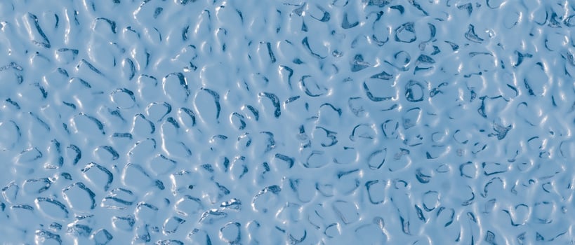 Background of uneven convex glass texture with ripple effect, water or ice imitation. photo
