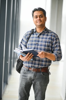 Portrait of cheerful male international Indian student with backpack. Education concept photo