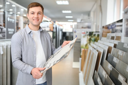 Male customer choosing kitchen ceramic tile in store photo