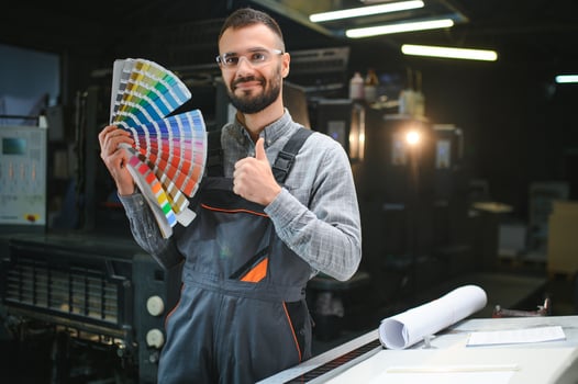 printing house, experimented technician works on UV printer. Production work photo