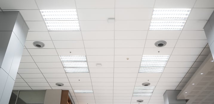 Ceiling mounted cassette type air conditioner and modern lamp light on white ceiling. Duct air conditioner for home, hall or office. photo