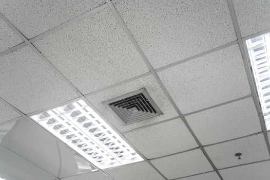 Ceiling mounted cassette type air conditioner and modern lamp light on white ceiling. Duct air conditioner for home, hall or office. photo