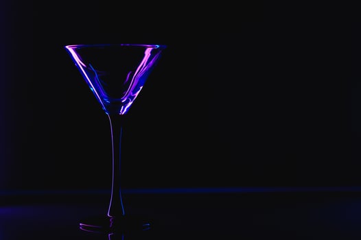 silhouette of martini glass on black background photo