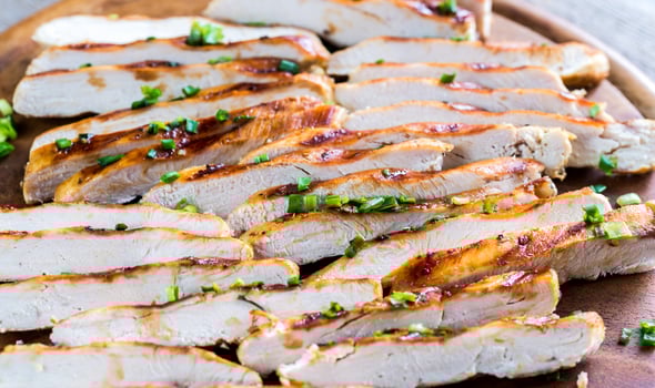 Slices of grilled chicken in lime sauce photo