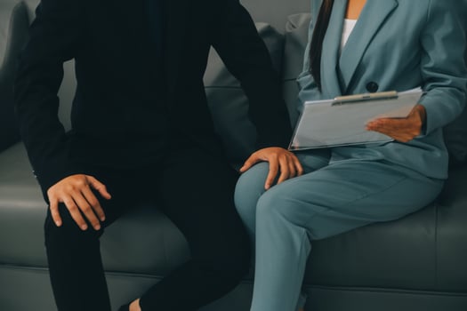 Sexsual harassment in workplace. Unhappy female employee looking at hand of boss touch at her shoulder and feeling disgusted. photo
