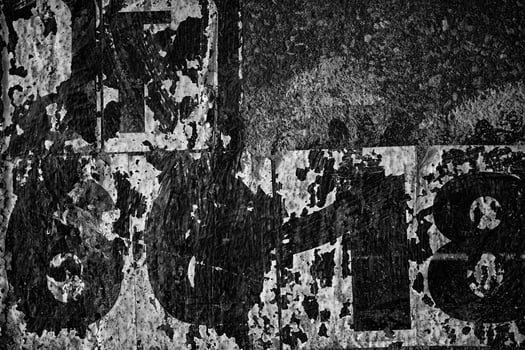 Old Peeling Vintage Posters on Grunge Concrete Wall Texture Background. photo