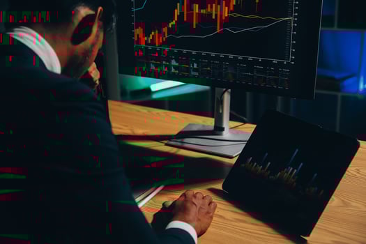 Thoughtful focused successful caucasian male stock investor, broker, financial adviser, sits at work desk, looks at computer, pensively analyze risks and prospects, rise or fall of cryptocurrency coin photo