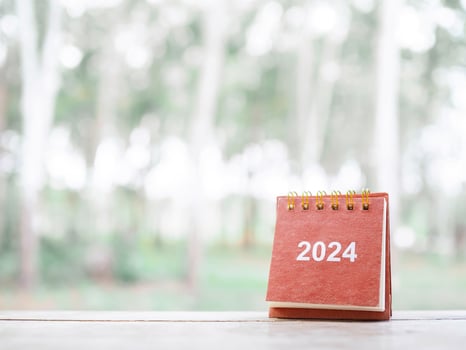 Close up 2024 desk calendar on the table with copy space. Resolution, Goal, Action, Planning, and manage to success business. photo