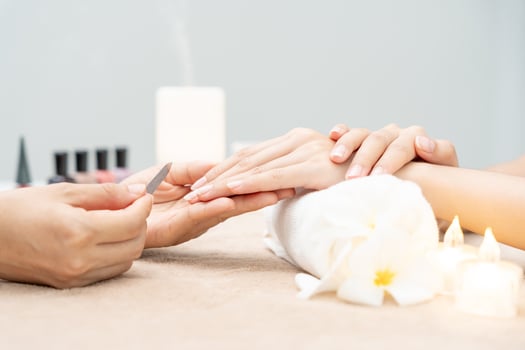 Woman receive care service by professional Beautician Manicure at spa centre. Nail beauty salon use nail file for Glazing treatment. manicurist make nail customer to beautiful. body care spa treatment photo