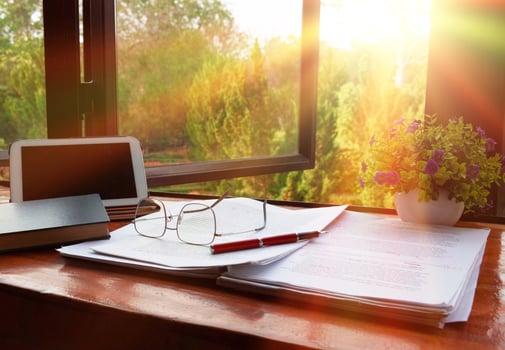 red pen over blurred paperwork for proofreading photo
