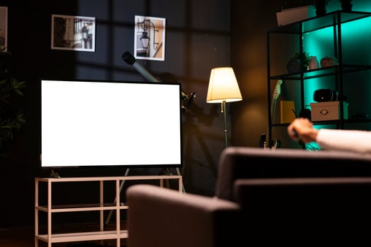 Man using streaming services on mockup TV to watch movies from the comfort of his personal cinema. Person enjoying films on isolated screen television set during leisure time in home theatre photo