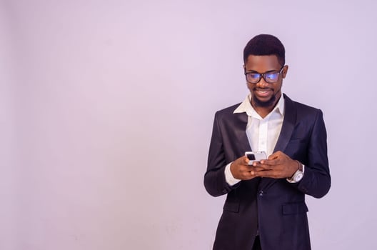 excited young black business man using his phone photo