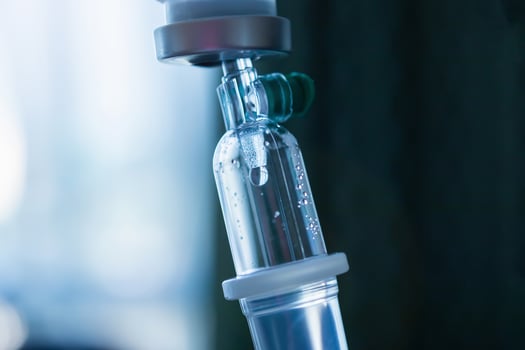 Close up medical intravenous IV drip in hospital background photo