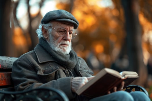 AI generated elderly man sitting on a bench in a park with a book in his hand, generative ai photo
