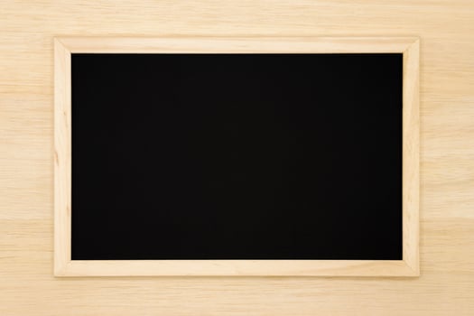 Blank chalkboard on wooden background. photo