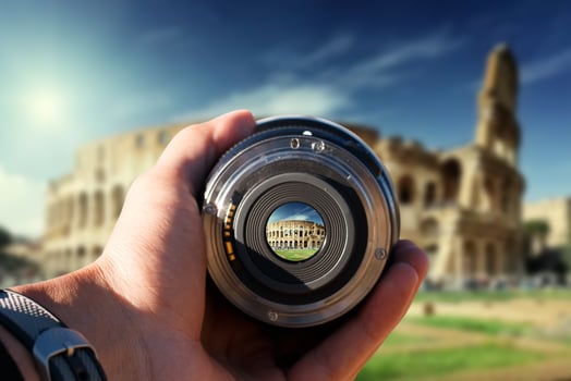 selective focus shot person holding camera lens on Colosseum tourist taking a picture with camera lens on Colosseum photo