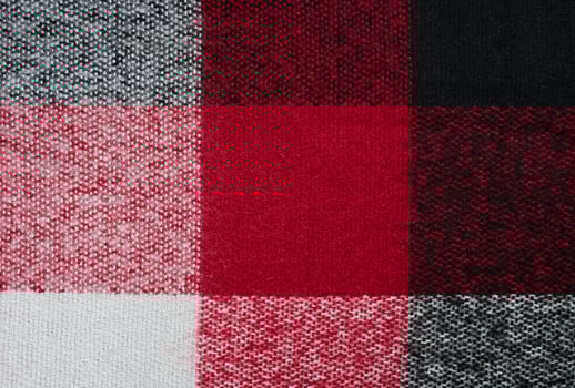 The texture of a warm woolen scarf. Checkered scarf for women. Abstract background. Selective focus. photo