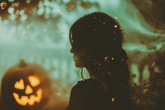 AI generated Halloween concept. Portrait of a beautiful girl in a witch costume with a pumpkin on the background of the night city. photo