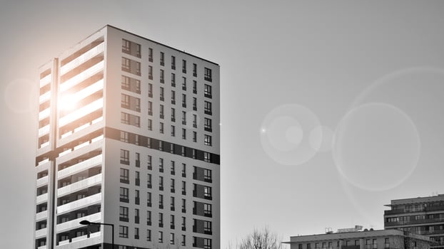 Fragment of the building's facade with windows and balconies. Modern apartment buildings on a sunny day. Facade of a modern residential building. Black and white. photo