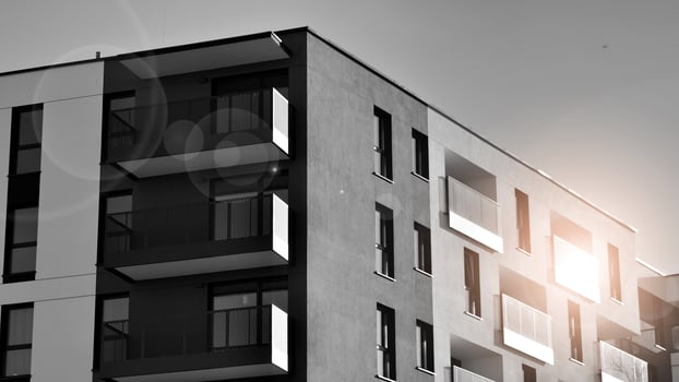 Fragment of the building's facade with windows and balconies. Modern apartment buildings on a sunny day. Facade of a modern residential building. Black and white. photo