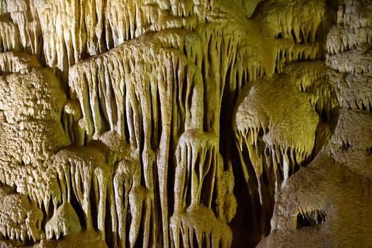 The cave is karst, amazing view of stalactites and stalagnites illuminated by bright light, a beautiful natural attraction in a tourist place. photo