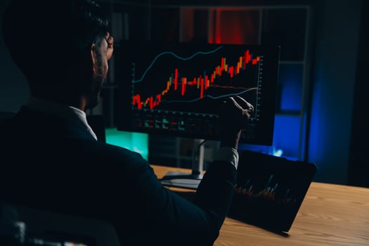 Thoughtful focused successful caucasian male stock investor, broker, financial adviser, sits at work desk, looks at computer, pensively analyze risks and prospects, rise or fall of cryptocurrency coin photo