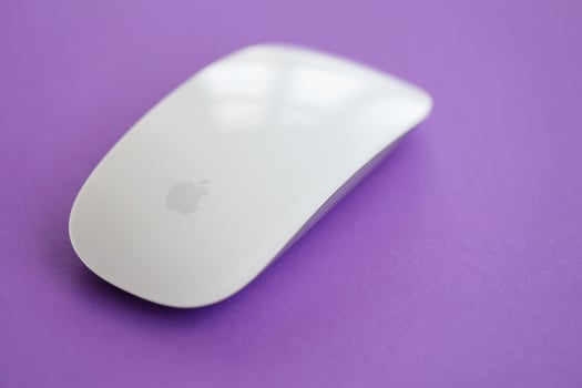 KYIV, UKRAINE - NOVEMBER 27, 2023 Apple Magic Mouse 3rd generation lies on bright colored background photo