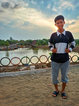 A boy on a mangrove beach in the afternoon photo