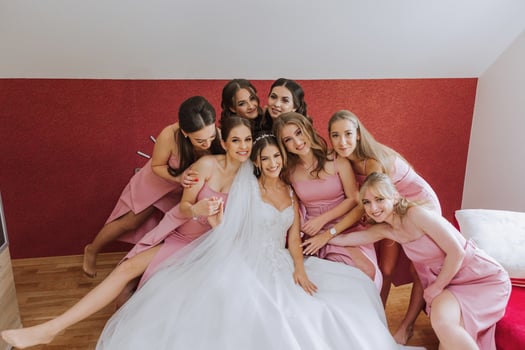 A beautiful bride and her bridesmaids are having fun in the morning. Wedding celebration. Happy girls at their best friend's wedding. A beautiful and elegant bride with her bridesmaids photo