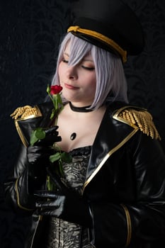 dominant woman in black uniform with a rose in her hand photo