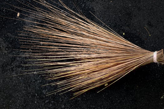 The texture of the palm fiber broom, which is often used to sweep floors or clean dirty wall surfaces, can be seen from the front with natural lighting. photo