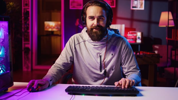 Esports player playing videogames in front of audience during livestream, providing engaging commentary participating in competition. Panning shot of professional gamer streaming game in studio photo