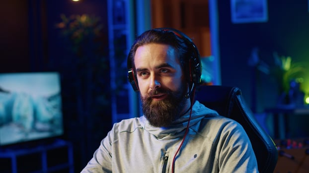 Streamer in studio playing videogames, streaming for online viewers, talking with them about upcoming esports competition. Pro gamer broadcasting gameplay in front of internet audience photo