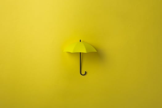 Yellow umbrella isolated on purple background. photo