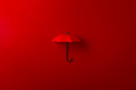 Red umbrella isolated on purple background. photo