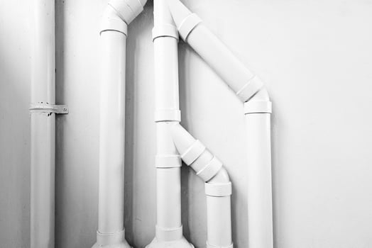 White Pipes on Concrete Wall with Light Beam and Shadow. photo