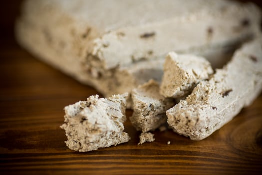 piece of sweet halva on a wooden table photo